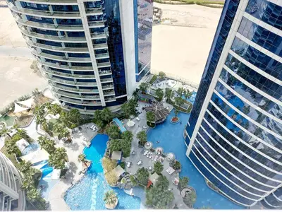 an aerial view of a resort with a pool and buildings at Damac Paramount Tower in Dubai