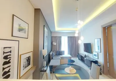 a living room with a couch and a table at Damac Paramount Tower in Dubai