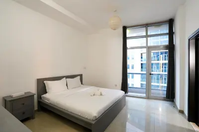 a bedroom with a bed with a stuffed animal on it at Great Flat Near Marina & Beach With Amazing View, Many Activities in Dubai