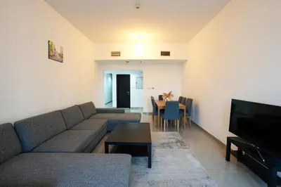 a living room with a couch and a table at Great Flat Near Marina & Beach With Amazing View, Many Activities in Dubai