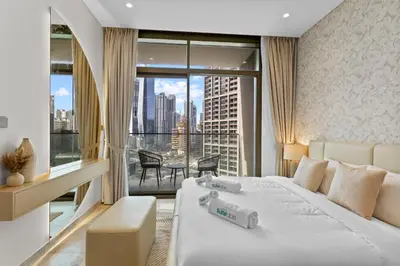 a hotel room with a bed and a large window at Sleek 1Bedroom with Burj Khalifa view in Peninsula in Dubai