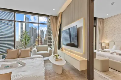 a hotel room with a bed and a large window at Sleek 1Bedroom with Burj Khalifa view in Peninsula in Dubai