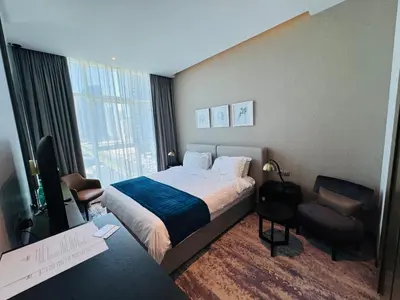 a hotel room with a bed and a window at Maison Prive By DAMAC Studio in Dubai