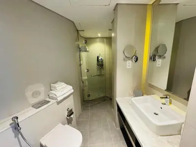 a bathroom with a sink and a toilet and a shower at Maison Prive By DAMAC Studio in Dubai