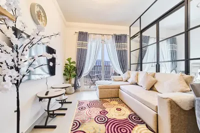 a living room with a couch and a table at Modern 1BR Retreat in Dubai Hills Prime Location in Dubai