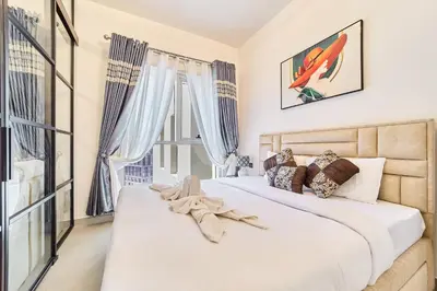 a bedroom with a large bed and a window at Modern 1BR Retreat in Dubai Hills Prime Location in Dubai