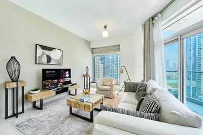 a living room with a couch and a tv at 2BR at Lofts West Near Dubai Mall and Burj Khalifa in Dubai