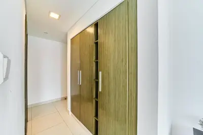 a wooden door in the hallway of a house at 2BR at Lofts West Near Dubai Mall and Burj Khalifa in Dubai