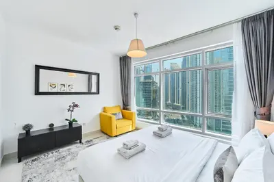 a bedroom with a bed and a large window at 2BR at Lofts West Near Dubai Mall and Burj Khalifa in Dubai