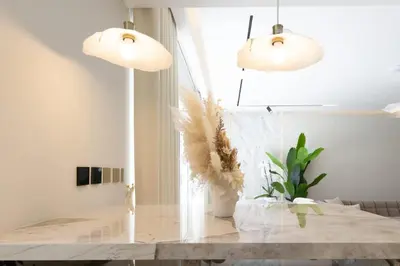 a dining room with two pendant lights and a table at Villa Zalex Springs 14 Luxury Living with Private Pool in Dubai