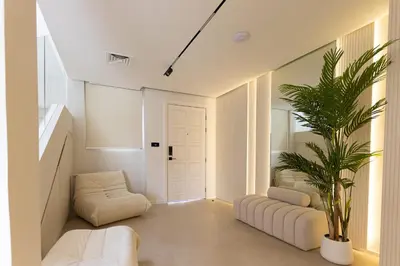 a living room with white furniture and a plant at Villa Zalex Springs 14 Luxury Living with Private Pool in Dubai