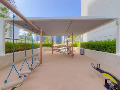 a gym with swings and a bench in a building at Cozy 1 BR in the Center - 5 mins to Burj Khalifa in Dubai
