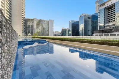 a swimming pool in a city with tall buildings at Cozy 1 BR in the Center - 5 mins to Burj Khalifa in Dubai