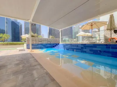 a swimming pool with a view of the city at Cozy 1 BR in the Center - 5 mins to Burj Khalifa in Dubai