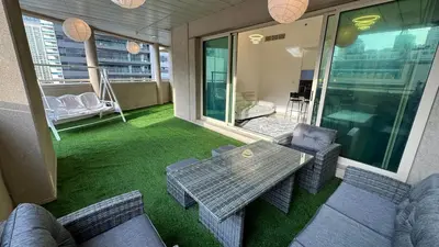 a patio with a table and chairs on a balcony at 2BHK Garden Apartment at the heart of Dubai Marina in Dubai