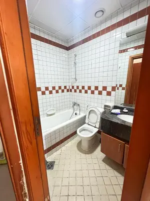a bathroom with a tub and a toilet and a sink at 2BHK Garden Apartment at the heart of Dubai Marina in Dubai