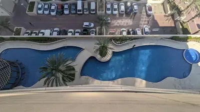 an overhead view of a swimming pool at a resort at 2BHK Garden Apartment at the heart of Dubai Marina in Dubai