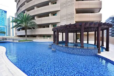 a large swimming pool in front of a building at 1 Bedroom in Dubai Marina opp Dmcc metro station in Dubai