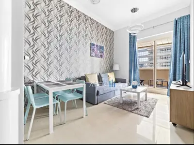 a living room with a table and a couch at 1 Bedroom in Dubai Marina opp Dmcc metro station in Dubai