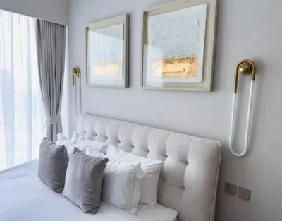a white bed with two pillows in a bedroom at GRANDE SIGNATURE with a direct Burj Khalifa view and Private Fountain Show at high floor with DXB AIRPORT VIP Shuttle option for 6 guests in Dubai