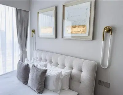 a bedroom with a white couch and a window at GRANDE SIGNATURE with a direct Burj Khalifa view and Private Fountain Show at high floor with DXB AIRPORT VIP Shuttle option for 6 guests in Dubai