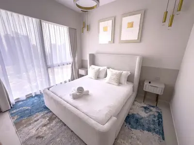 a bedroom with a white bed and a large window at GRANDE SIGNATURE with a direct Burj Khalifa view and Private Fountain Show at high floor with DXB AIRPORT VIP Shuttle option for 6 guests in Dubai