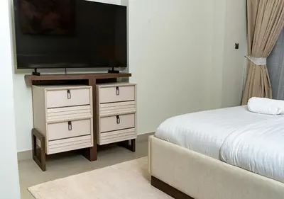 a bedroom with a bed and a flat screen tv at 2BR Apartment In Dubai in JVC near Circle mall in Dubai