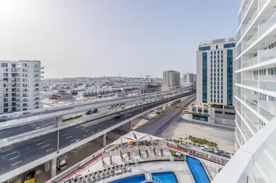 an overhead view of a highway in a city with buildings at City Views 2BR and Assistant Room with Mini Private Pool in Balcony, Gemz by Danube, Al Furjan by Deluxe Holiday Homes in Dubai