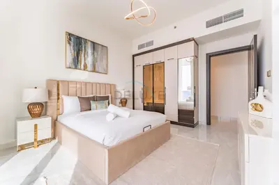 a white bedroom with a large bed and a mirror at City Views 2BR and Assistant Room with Mini Private Pool in Balcony, Gemz by Danube, Al Furjan by Deluxe Holiday Homes in Dubai