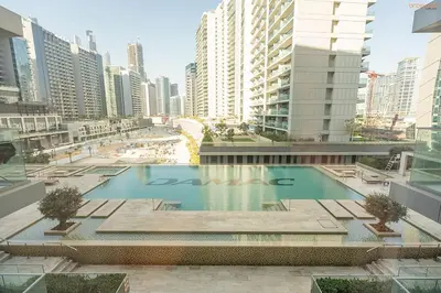 a large swimming pool in a city with tall buildings at Bnbeyond's Artsy Canal-View Studio in the Heart of BBay in Dubai
