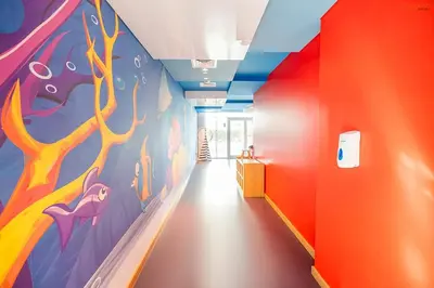 a hallway with a colorful mural on the wall at Bnbeyond's Artsy Canal-View Studio in the Heart of BBay in Dubai