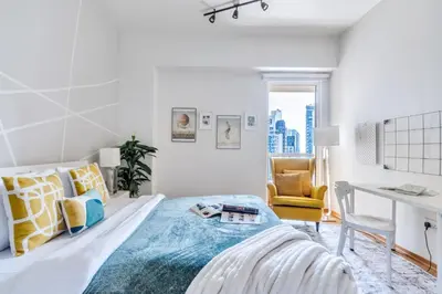 a white bedroom with a bed and a desk at The Smart Concierge - Rimal 4 in Dubai