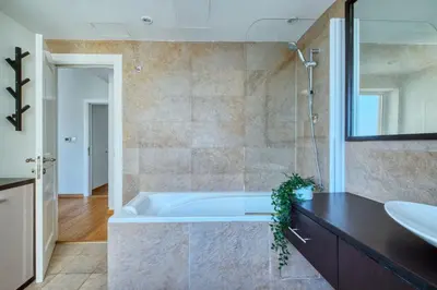 a bathroom with a tub and a sink at The Smart Concierge - Rimal 4 in Dubai