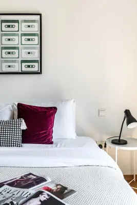 a bedroom with a white bed with a red pillow at The Smart Concierge - Rimal 4 in Dubai