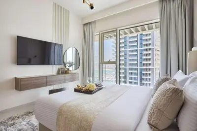 a bedroom with a large bed and a large window at Frank Porter - Grand Bleu Tower 2 in Dubai