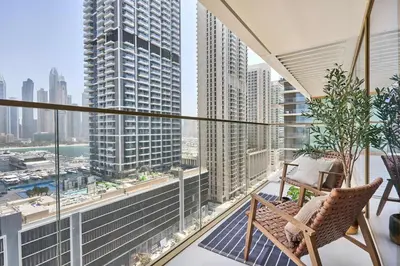 a balcony with a chair and a view of a city at Frank Porter - Grand Bleu Tower 2 in Dubai