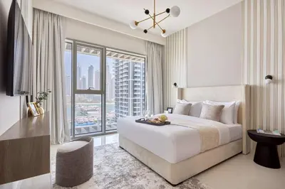 a bedroom with a large bed and a large window at Frank Porter - Grand Bleu Tower 2 in Dubai