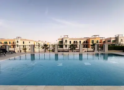 a large swimming pool with buildings in the background at La Sirene 1, Port De La Mer - Mint Stay in Dubai