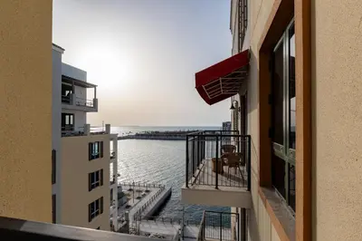 a view of the water from a balcony of a building at La Sirene 1, Port De La Mer - Mint Stay in Dubai