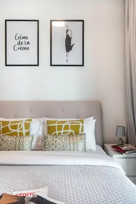 a bedroom with a bed with two pictures on the wall at The Smart Concierge - Binghatti Canal in Dubai