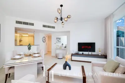 a living room with a couch and a table at LUX The Dubai Marina View Suite 2 in Dubai