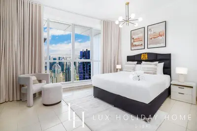 a bedroom with a bed and a large window at LUX The Dubai Marina View Suite 2 in Dubai