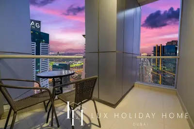 a balcony with a table and chairs and a view of a city at LUX The Dubai Marina View Suite 2 in Dubai