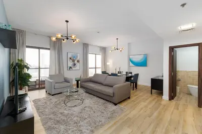 a living room with a couch and a table at Shams 1, Jumeirah Beach Residence - Mint Stay in Dubai