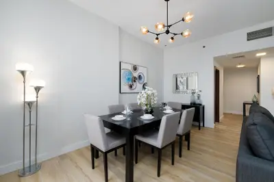 a dining room with a black table and chairs at Shams 1, Jumeirah Beach Residence - Mint Stay in Dubai