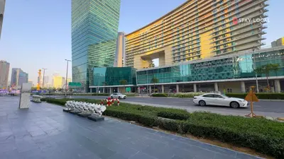 a city street with a large building and a car at Urban Living with Balcony, Pool, and Quick Access to Burj Khalifa in Dubai