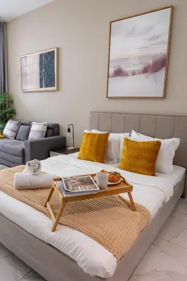 a bedroom with a bed with a coffee table on it at Urban Living with Balcony, Pool, and Quick Access to Burj Khalifa in Dubai