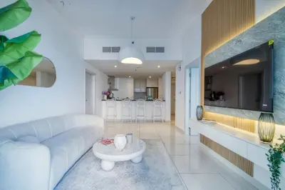 a living room with a couch and a table at The Smart Concierge - Damac Heights in Dubai