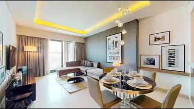 a living room with a table and a couch at Moderne 1BR apartment overlooking city in Dubai