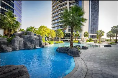 a swimming pool in the middle of a resort at Moderne 1BR apartment overlooking city in Dubai